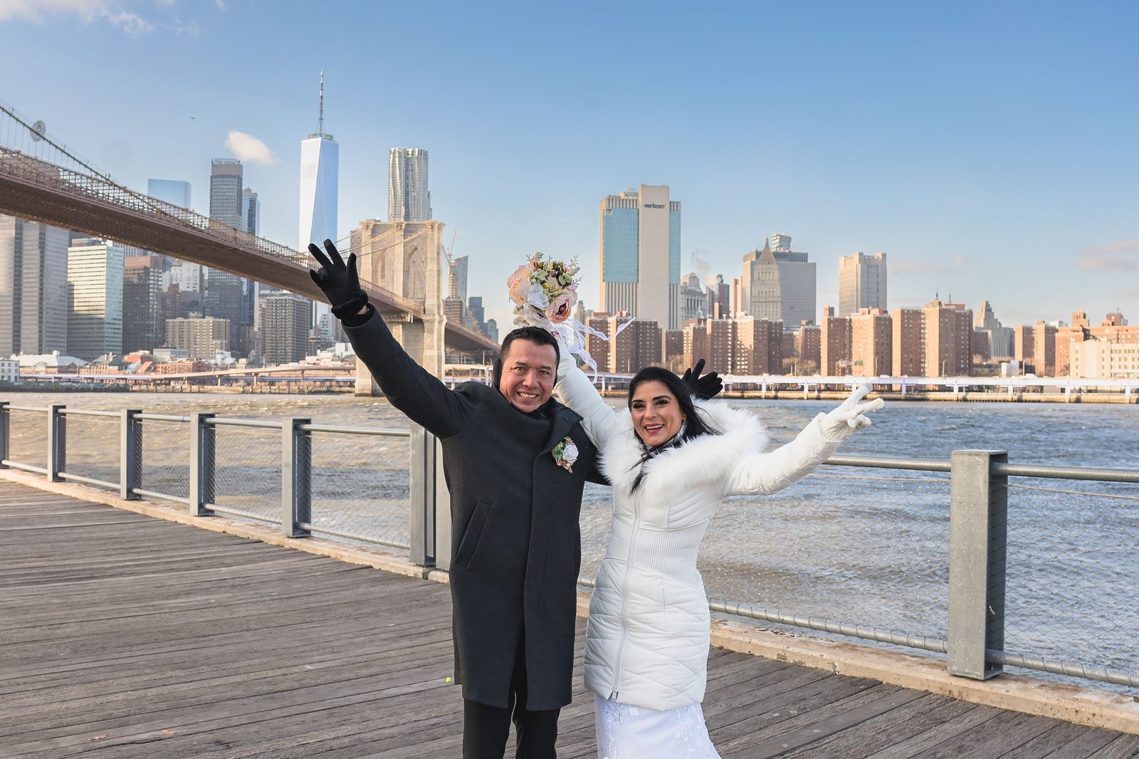 Newlyweds framed by the grand arches of the Empire Stores building at Brooklyn Bridge Park