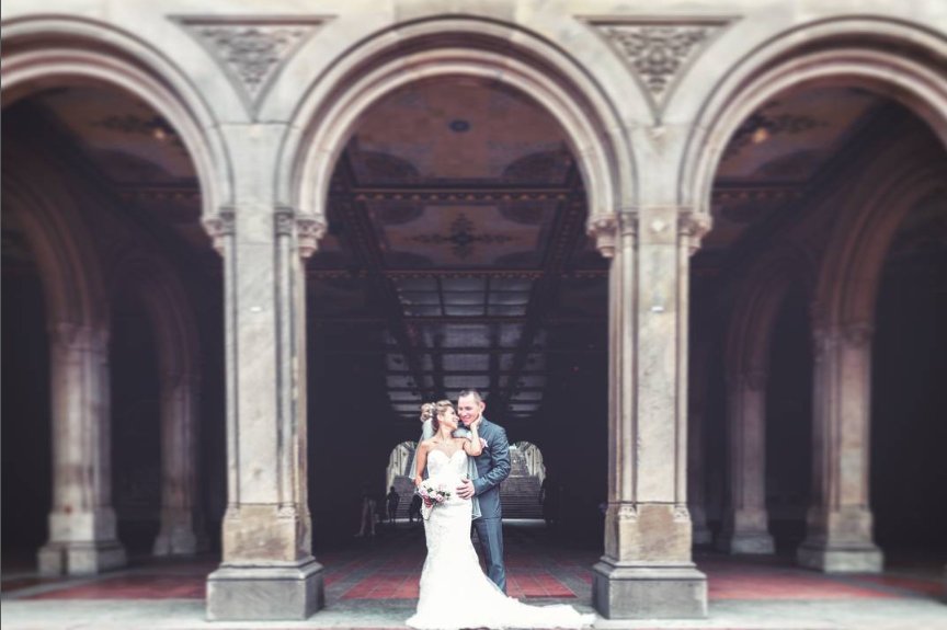 Newlyweds embracing beneath the Bethesda Terrace arches - Central Park Wedding - New York City