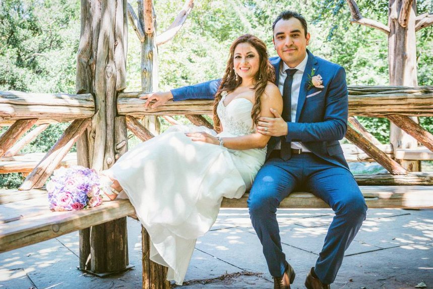 Newlyweds on the rustic bench at Cop Cot - Central Park Wedding - New York City