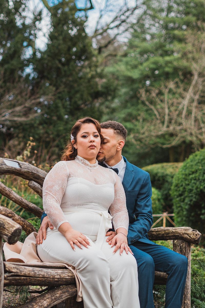 Couple embracing on a rustic bench in Shakespeare Garden - Central Park Wedding - New York City