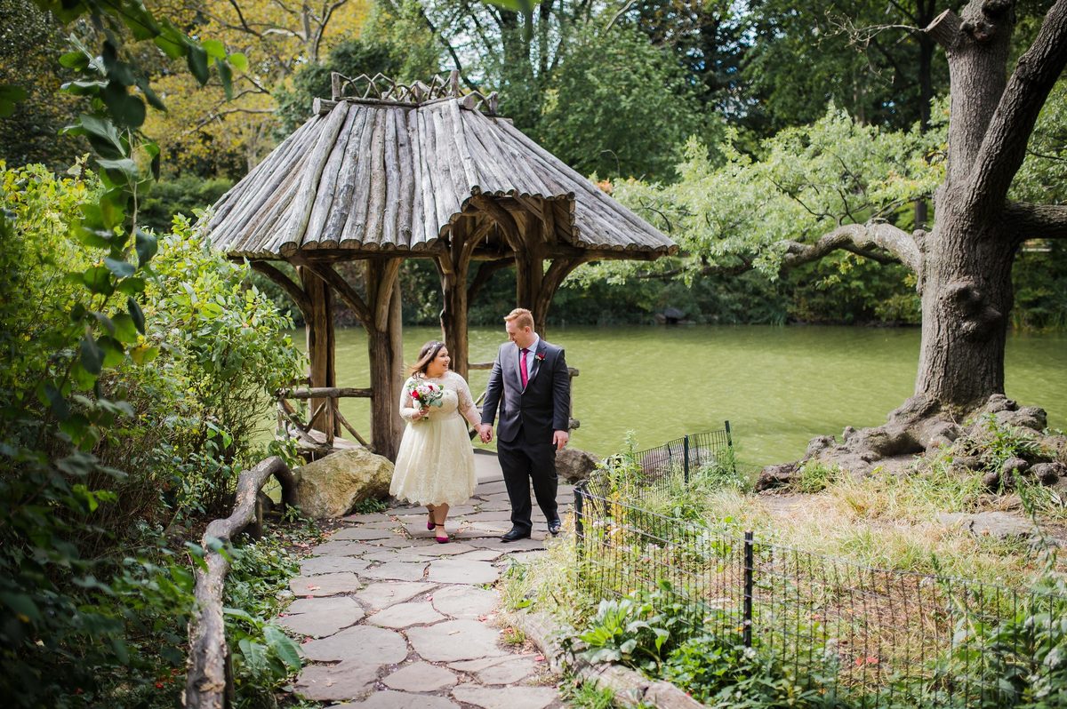 Newlyweds strolling hand in hand to the shelter at Wagner Cove - Central Park Wedding - New York City